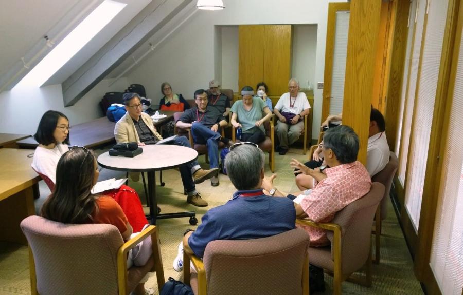 A group of people talking in a meeting room.