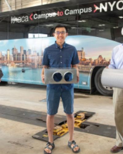 three people holding bus filter parts